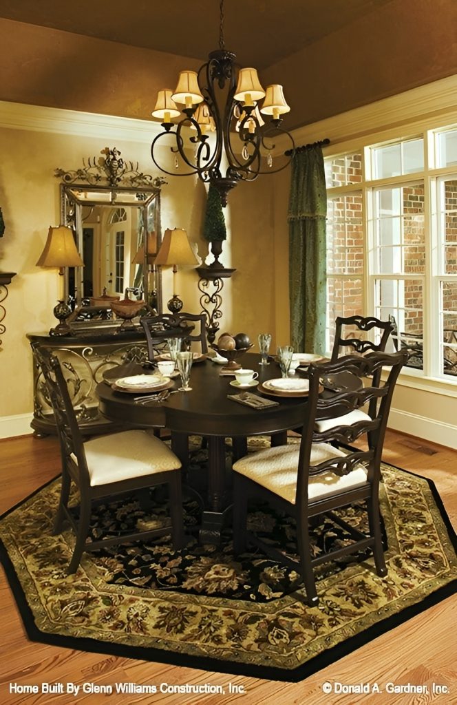 Formal dining room with a dark wood dining table and an intricate buffet bar paired with a chrome framed mirror.