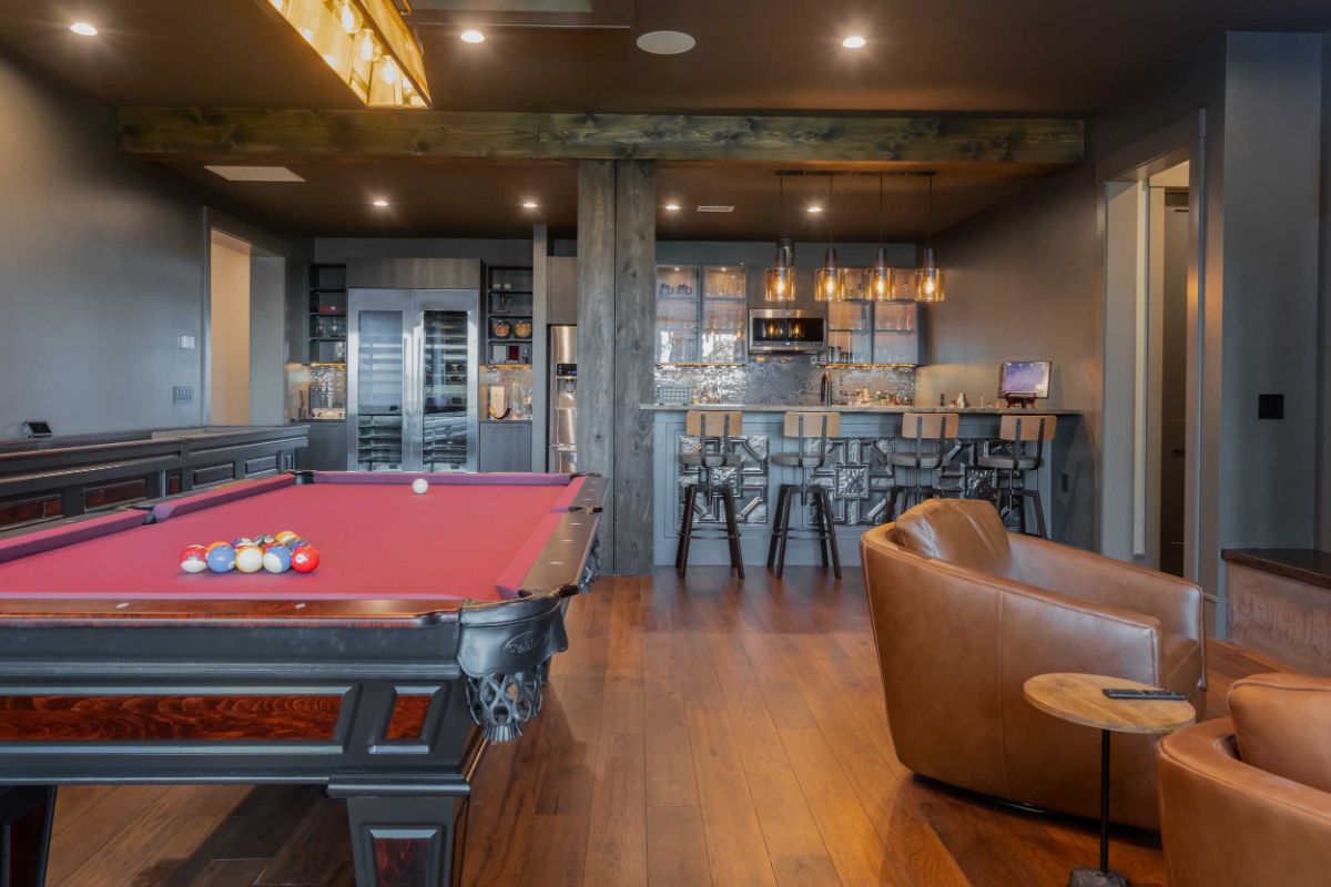 A gaming room and bar area with wooden timber beams and dark wooden floors creating a warmth atmosphere.