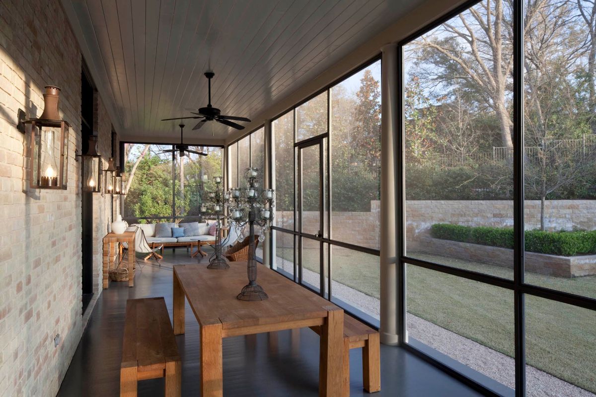 Dining and living areas complete the covered porch's traditional style, which includes the use of recycled timbers and vintage lighting fixtures.