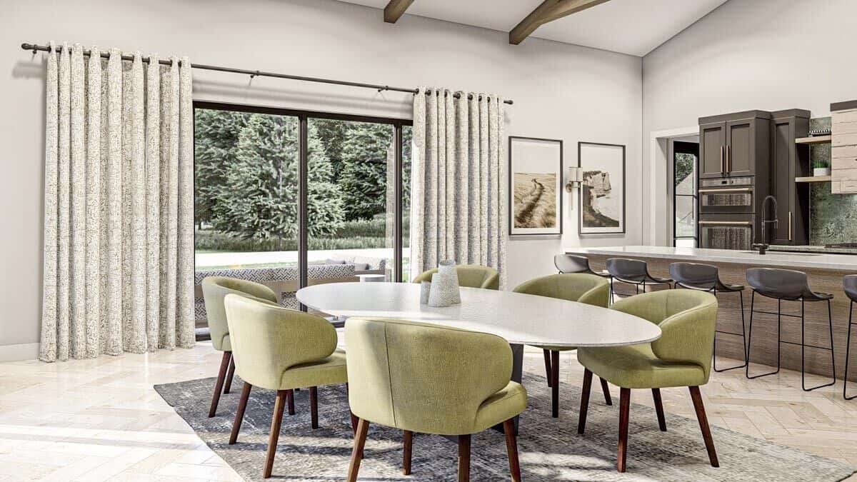 Dining area with an oval dining set and sliding glass doors that open onto the concrete patio.