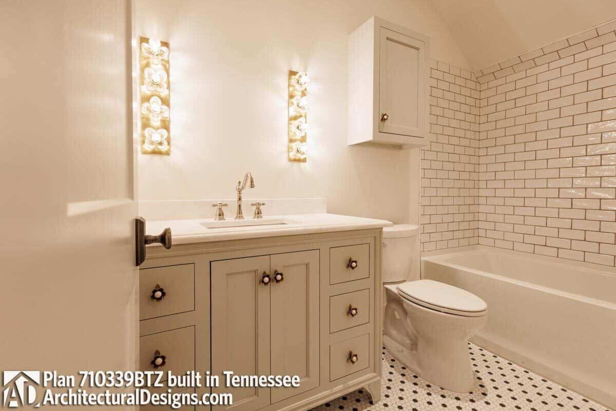 The shared bathroom offers a single sink vanity, a toilet, and a tub and shower combo.