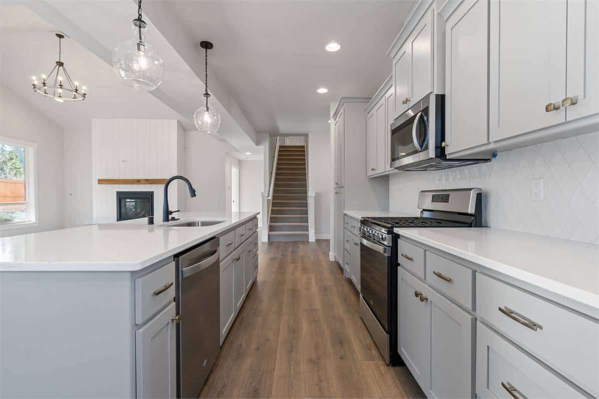 The kitchen offers ample storage, high-end appliances, and a center island with bar seating.