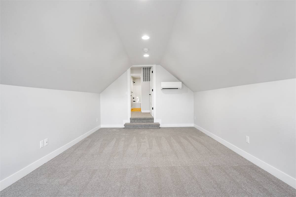 Bonus room with a vaulted ceiling and knee walls.