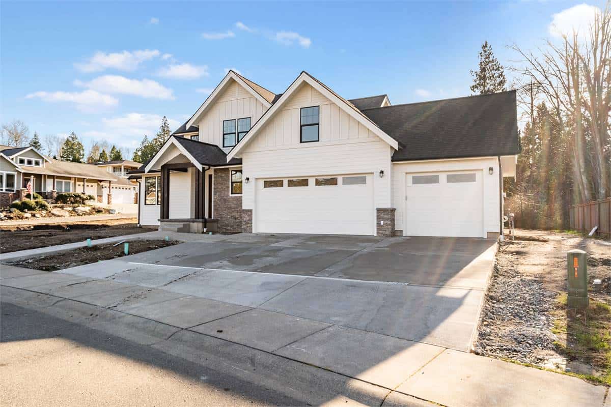 Front exterior view showcasing the covered entry porch and front-facing garage.