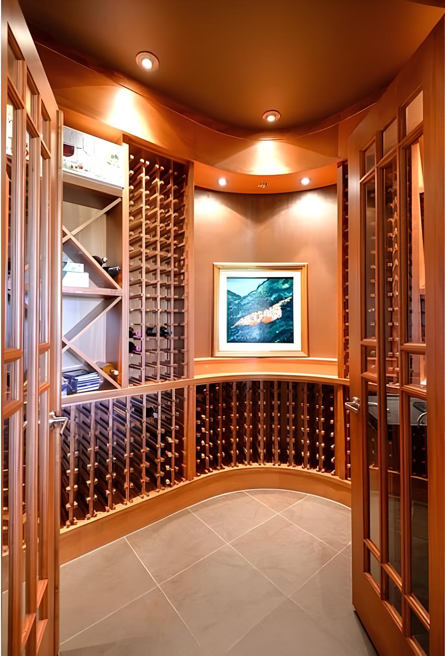 The wine cellar is filled with built-in cubbies and framed artwork.