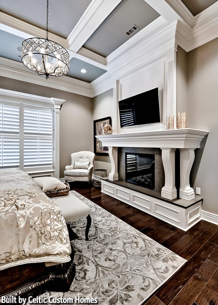 The opposite view shows the romantic fireplace complemented by a wall-mounted TV and wingback chair.