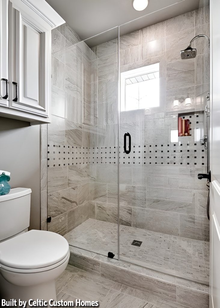 Bathroom with a walk-in shower and a toilet under the floating white cabinet.