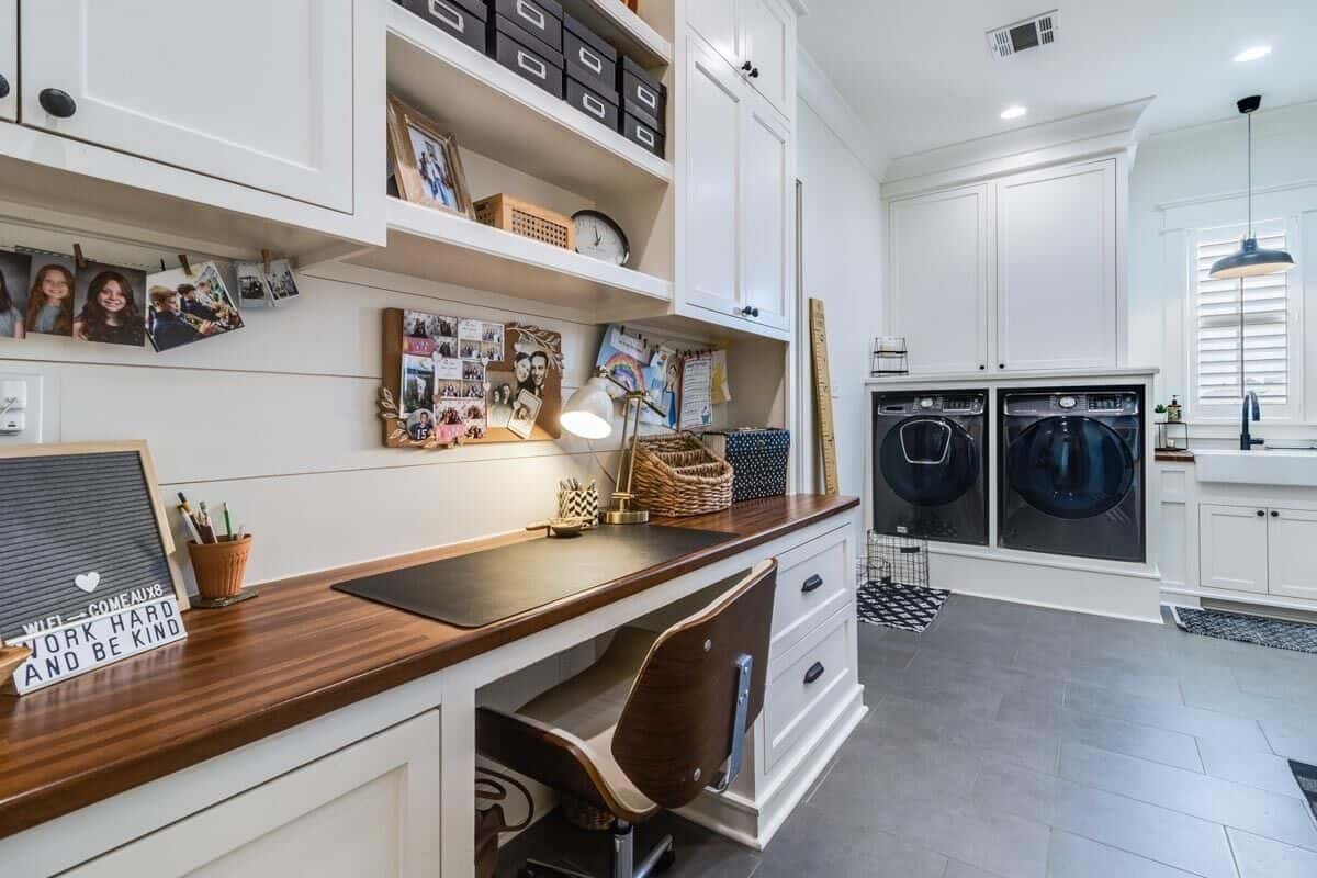 The utility room includes a large desk topped with overhead cabinets and shelves.