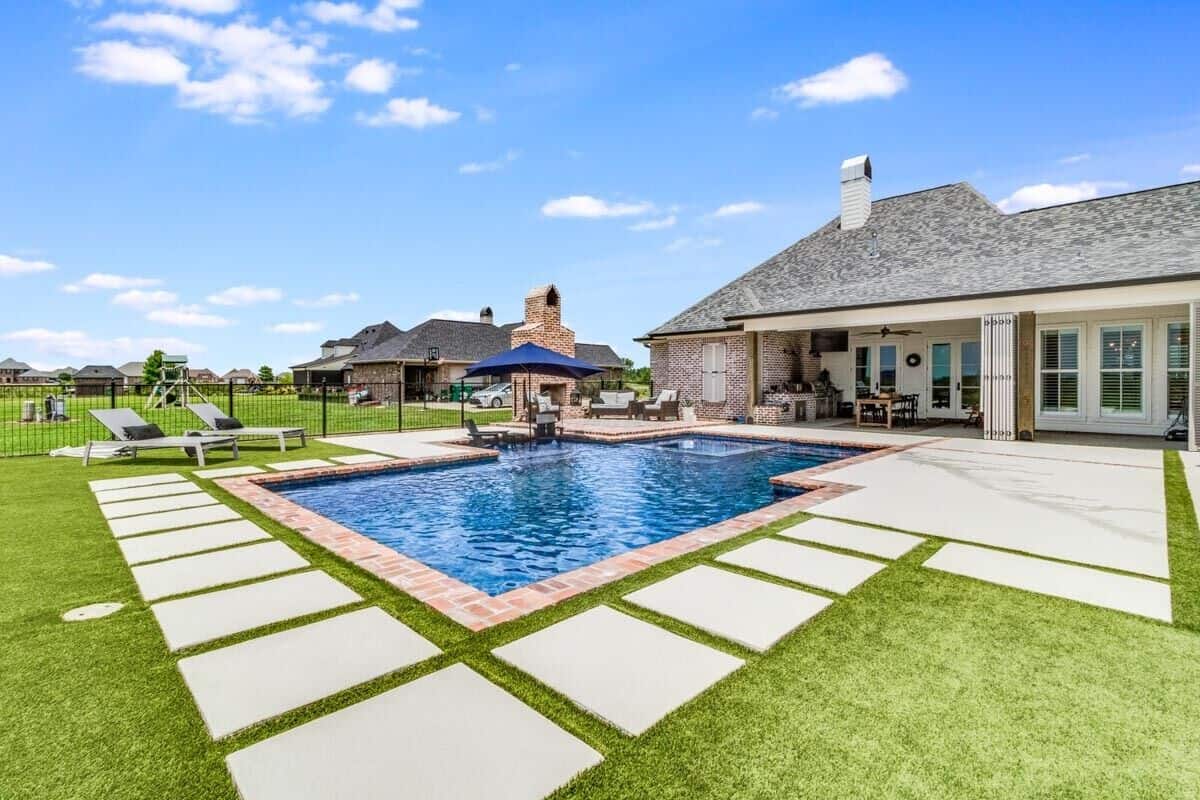 View of the house from the backyard showcasing the outdoor living and pool terrace.