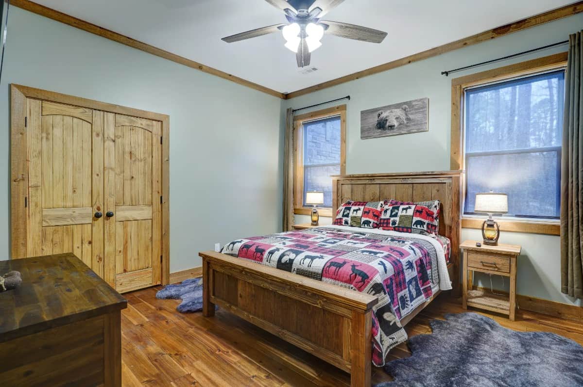 Another bedroom with hardwood flooring and wooden furnishings.