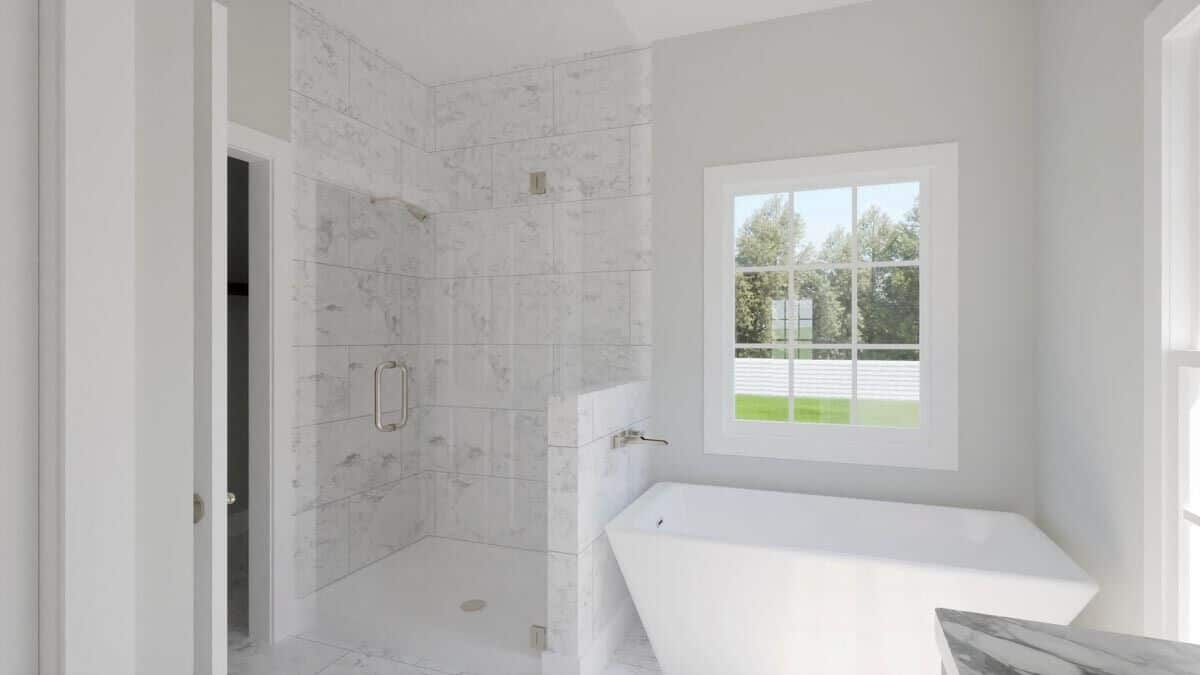 The primary bathroom includes a tiled shower and a freestanding tub brightened by a white-framed window.