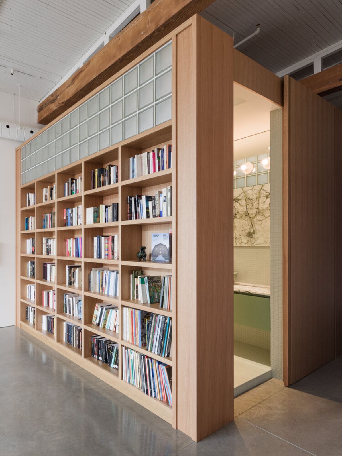 Built-in book shelf at home, beside is a well-ventilated bathroom.