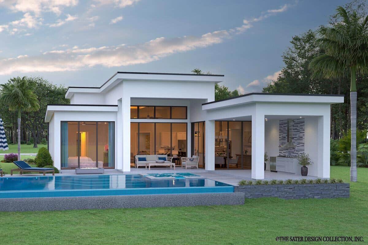 View of the house from the backyard showcasing its covered lanai, outdoor kitchen, and pool terrace.