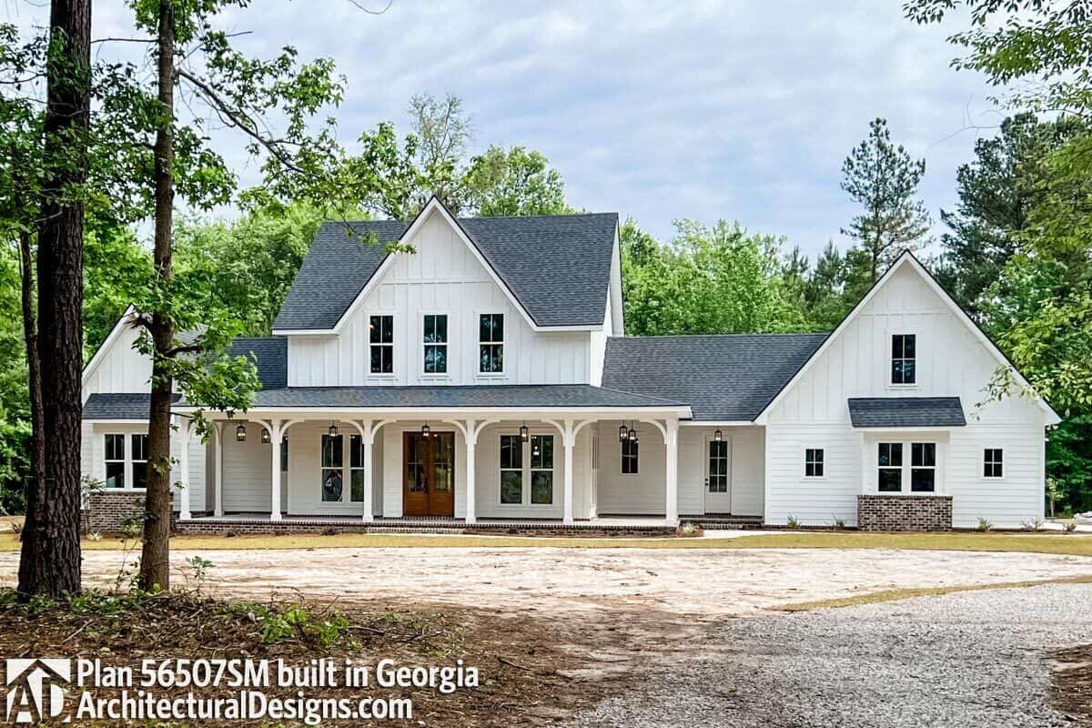 Front exterior view showcasing the expansive entry porch framed with decorative pillars.