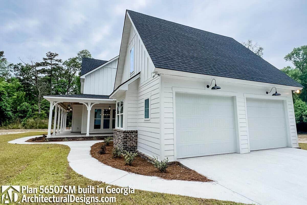 Right exterior view with a side-loading garage and concrete driveway.