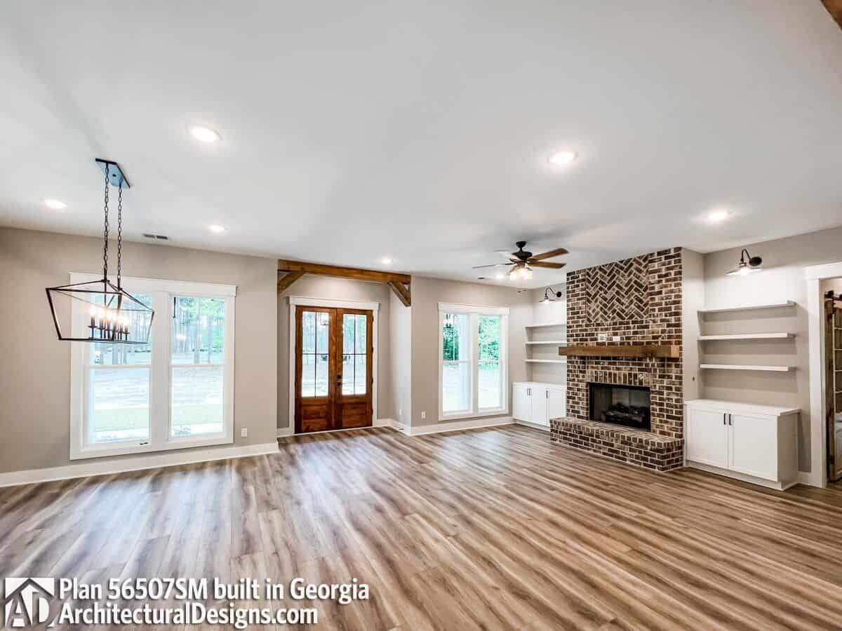 A French front door opens into the dining room and great room warmed by a brick fireplace.