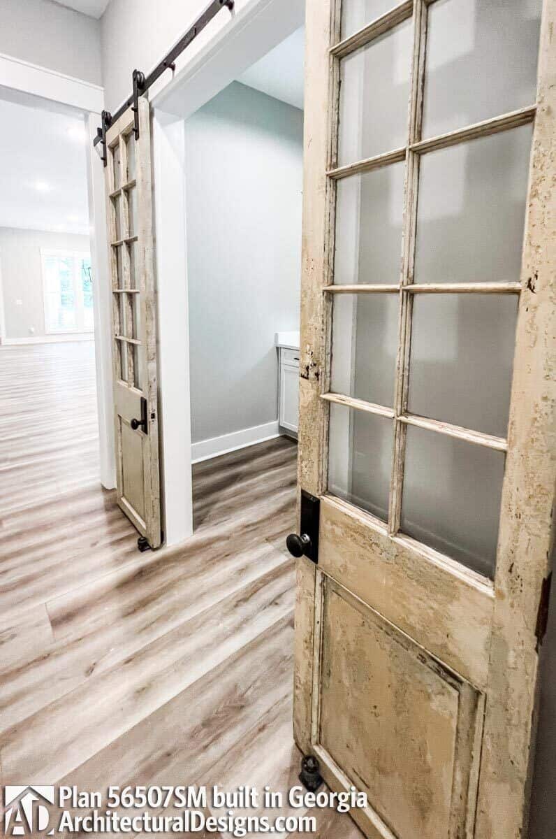 Double barn doors reveal the laundry room.