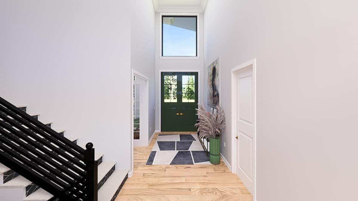 The foyer has a two-story ceiling and a French entry door topped with a large transom.