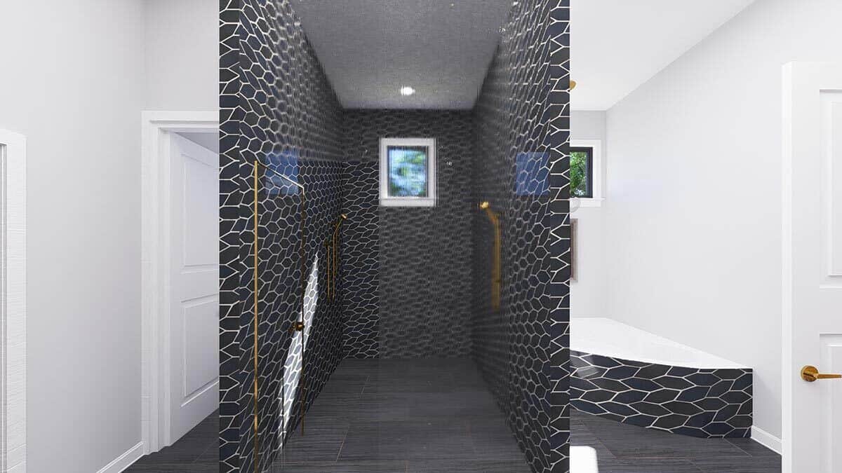 Decorative black tiles accentuated with brass fixtures highlight the primary walk-in shower.