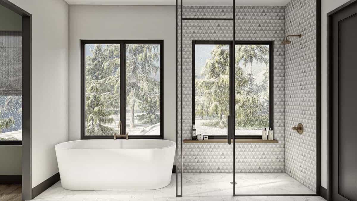 Primary bathroom with a freestanding tub and a walk-in shower encased in framed glass panels.