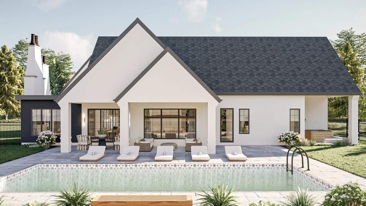 View of the house from the backyard showcasing the covered lanai and pool terrace.