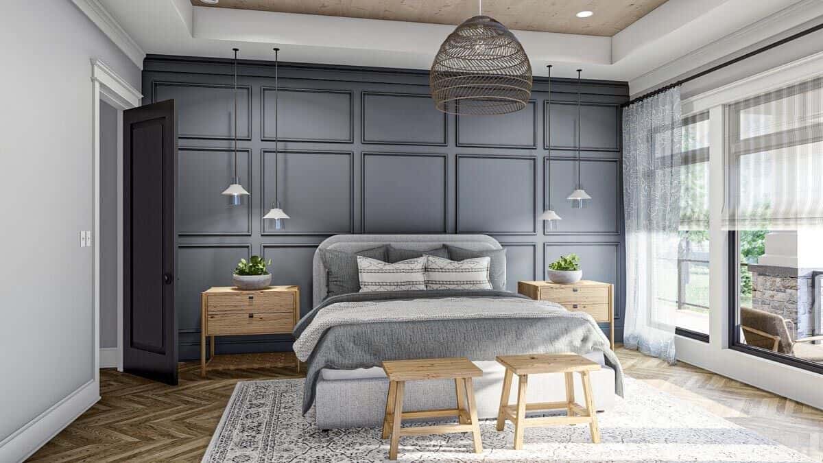 The primary bedroom features a tray ceiling and a gray paneled accent wall that sets a striking backdrop to the platform bed.