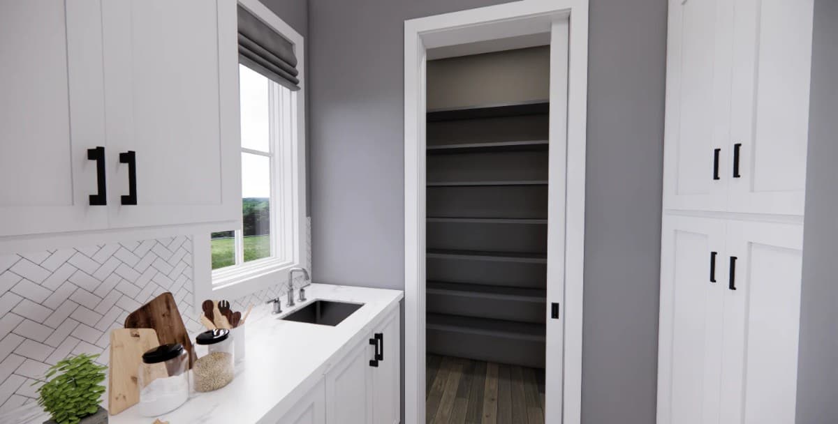 Prep kitchen with a sink, additional cabinets, and a walk-in pantry.