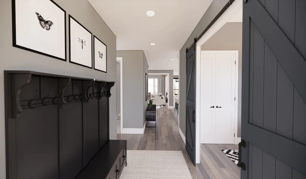 A wooden entry door opens into the foyer with a coat rack and storage bench.