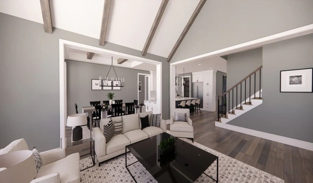 Living room with beige seats, an iron coffee table, and a vaulted ceiling accentuated with exposed beams.