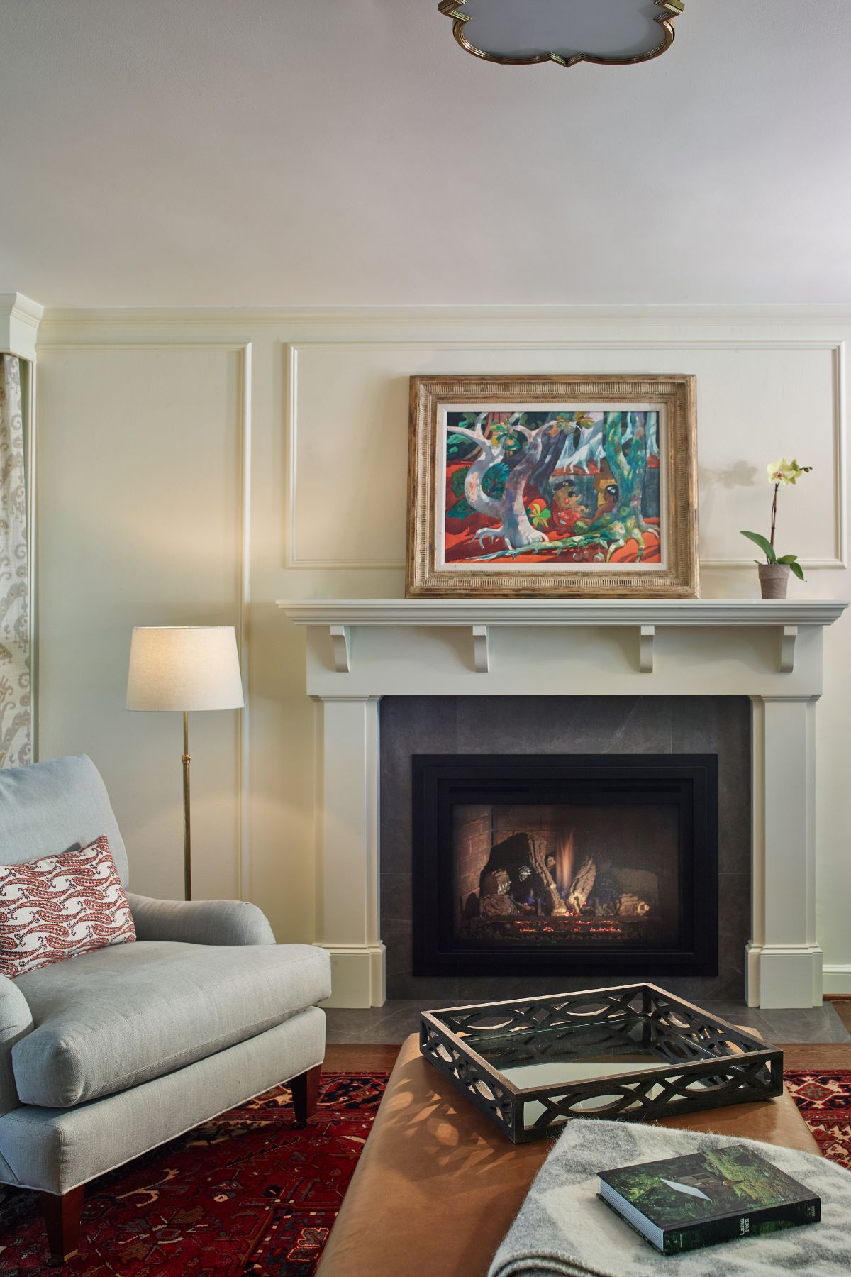 Featuring the fireplace in the living room with an artistic art piece in a frame against the wall.