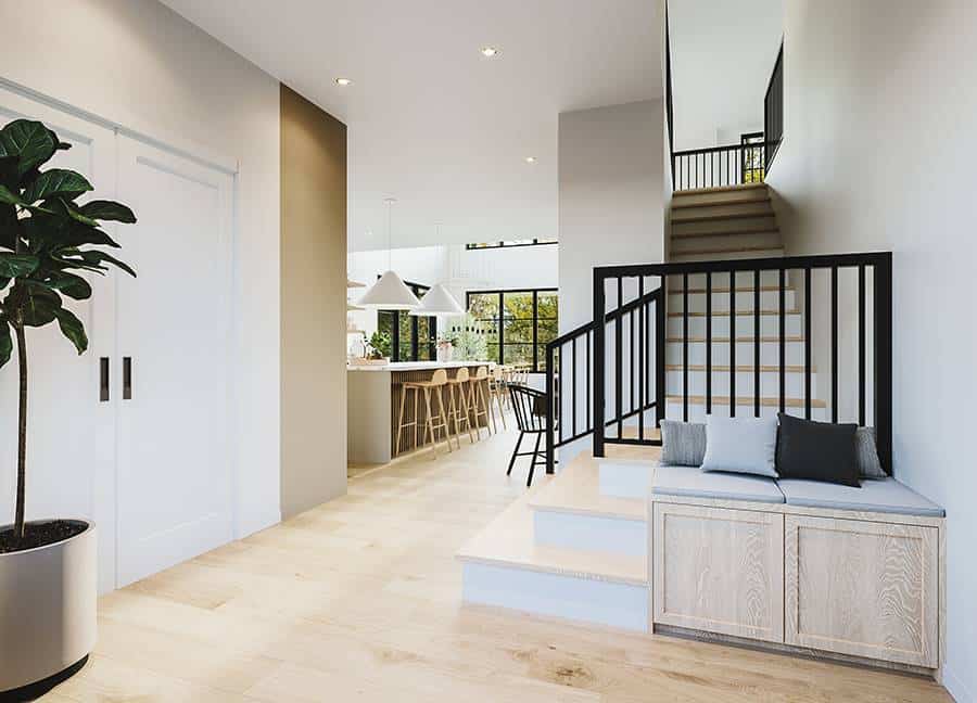 Foyer with a cushioned storage bench and a staircase leading to the upstairs bedrooms.