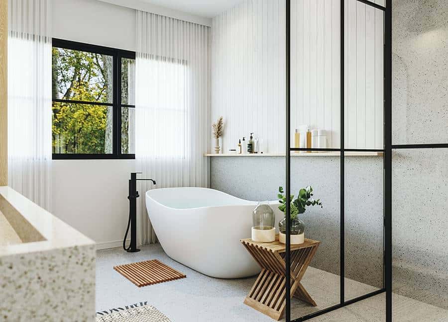 The primary bathroom has a walk-in shower and a freestanding tub complemented by a wooden stool.