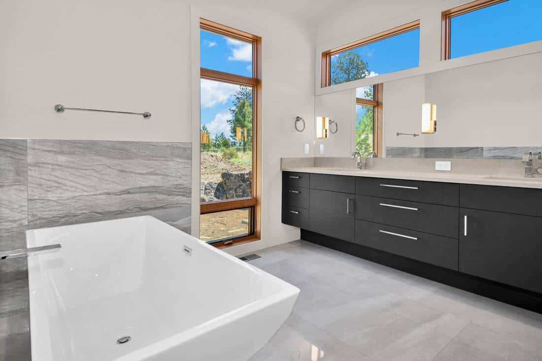 Primary bathroom with a deep soaking tub and a dual sink vanity.