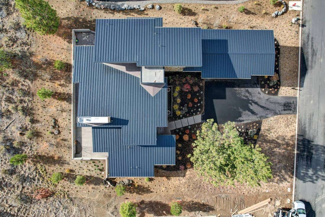 Aerial view of the house showcasing its metal roofs and outdoor spaces.