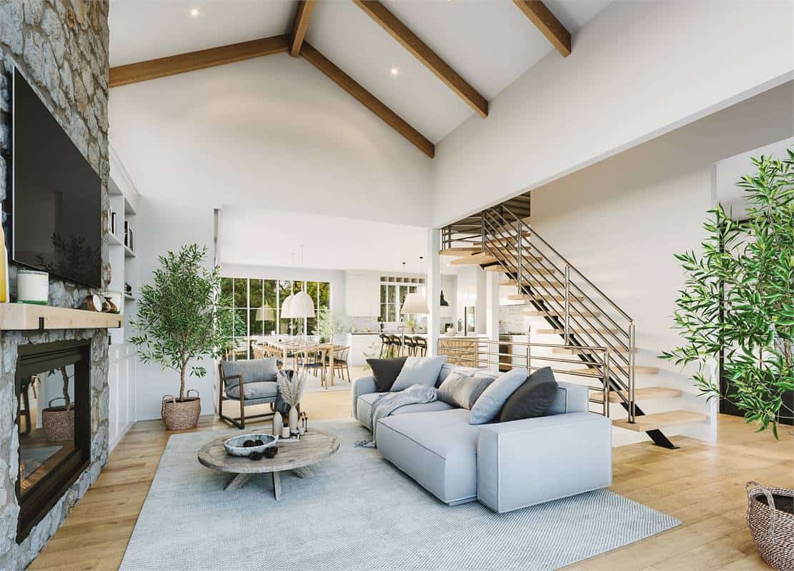 The living room features gray seats, a low coffee table, and a large TV mounted above the fireplace.