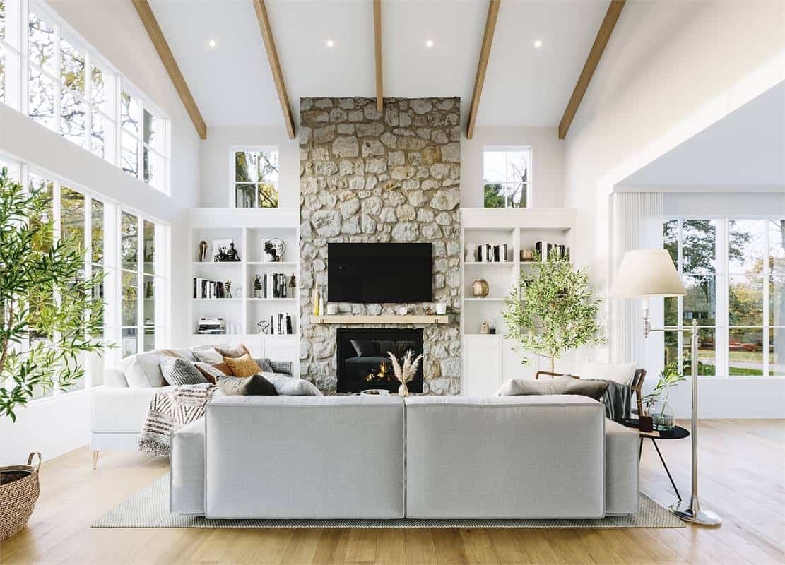 The living room includes huge windows and built-in shelves flanking the stone fireplace.