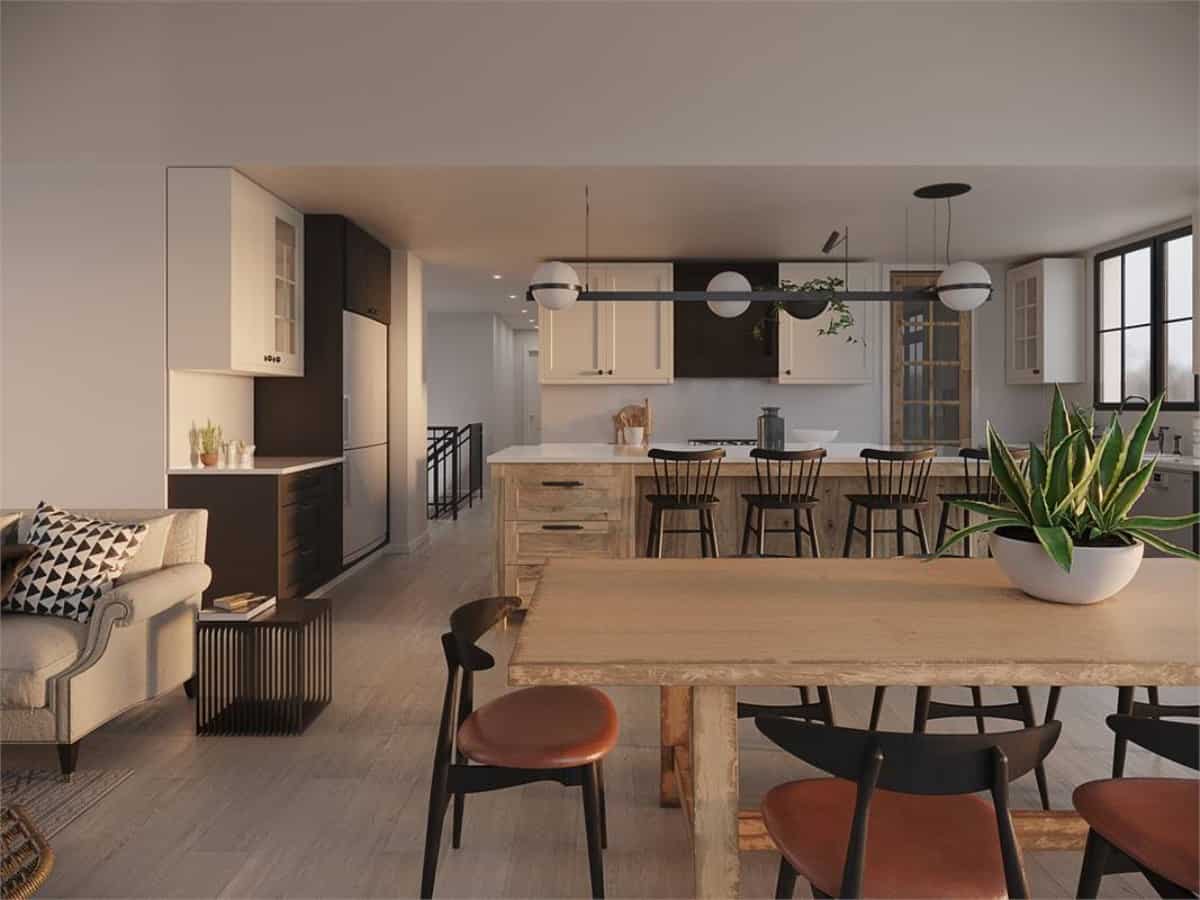 The dining area with a wooden table and round back chairs connect the living room to the kitchen.