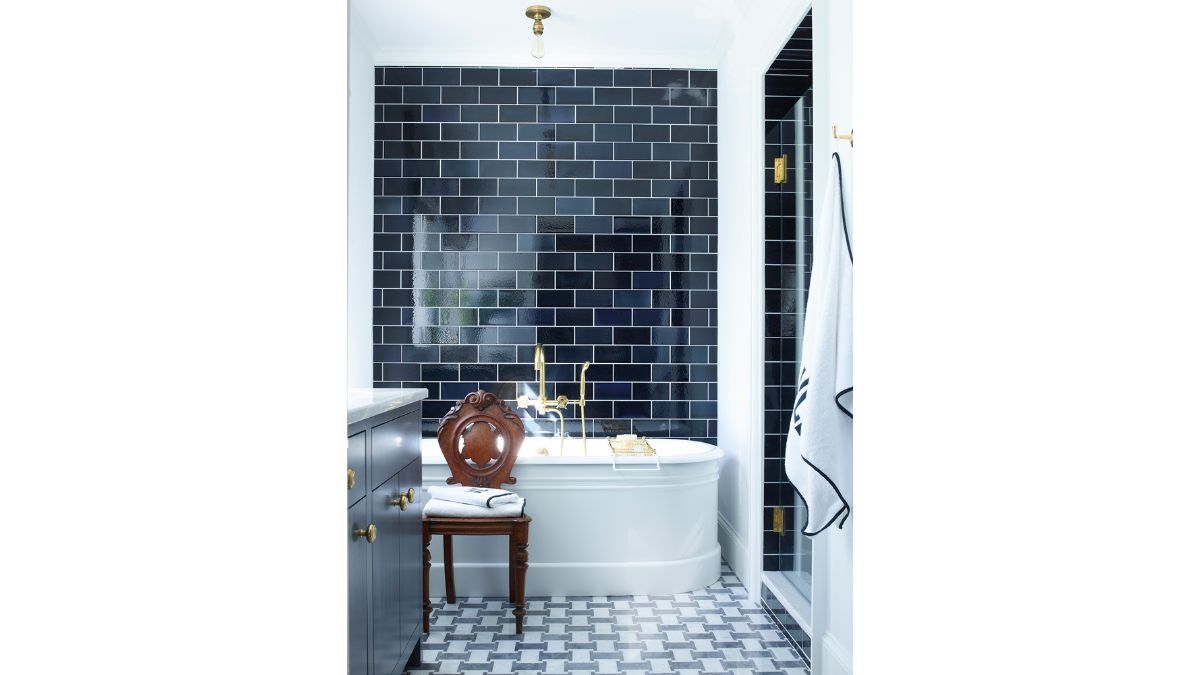 The bathroom showcases an elegant design, complete with a bathtub and coordinated grey-themed furnishings and walls.