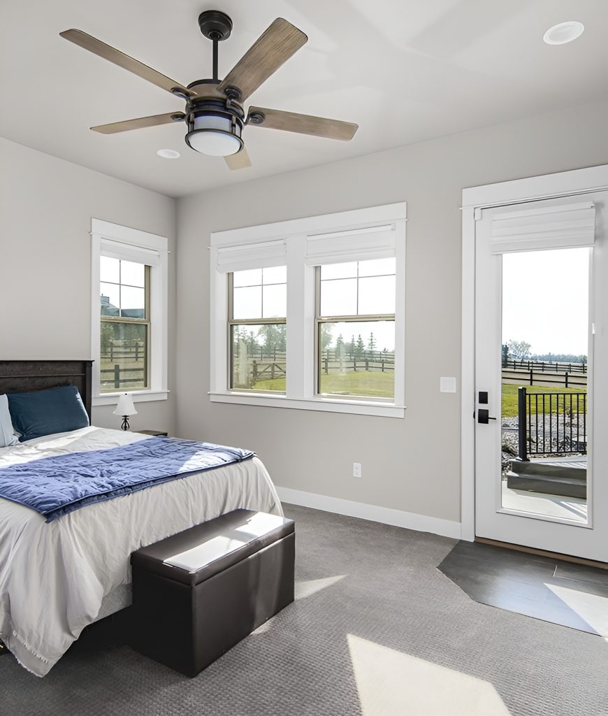 This bedroom has carpet flooring, a ceiling fan, and outdoor access.