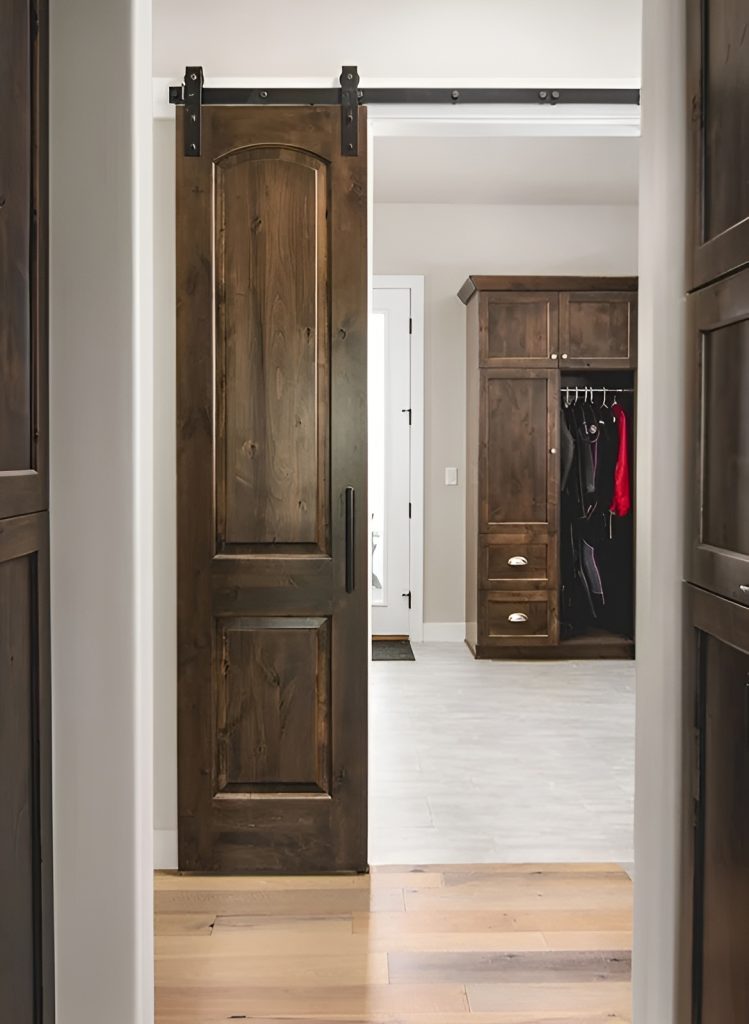 A sliding barn door opens to the primary closet.