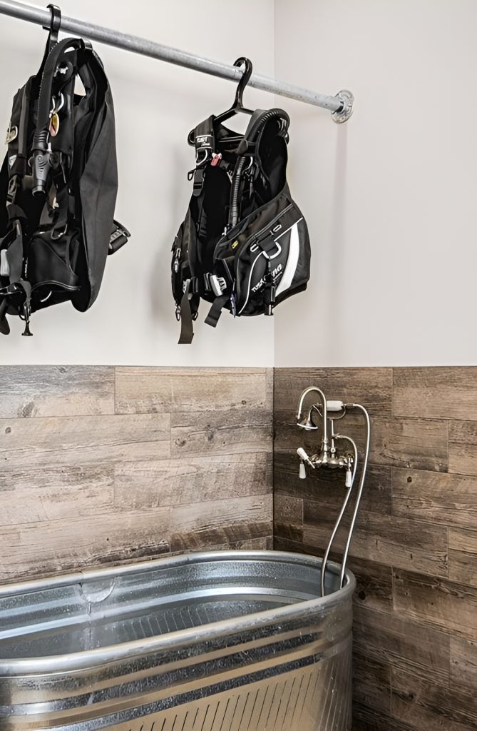 Bathroom with a deep soaking tub topped with a pole rack.