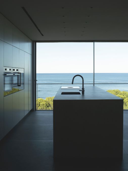 a kitchen with a sink and a floor to ceiling window