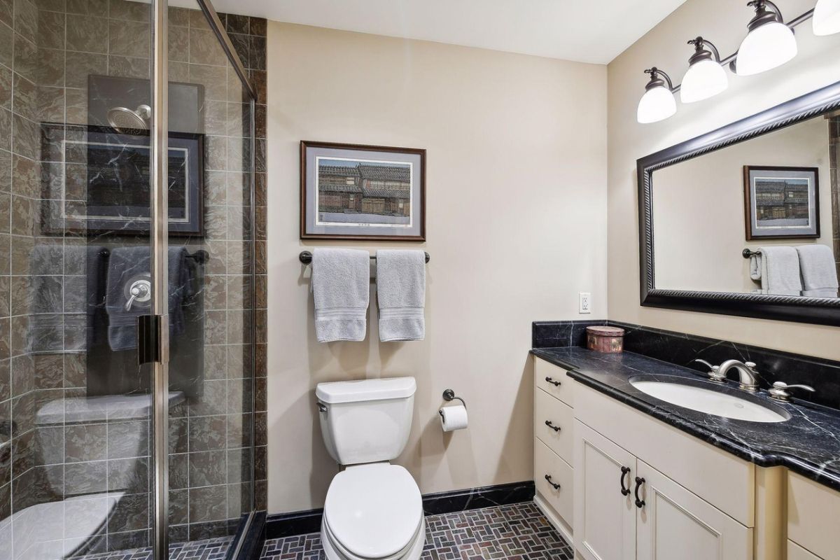 Bathroom with a sink, shower, and a toilet.