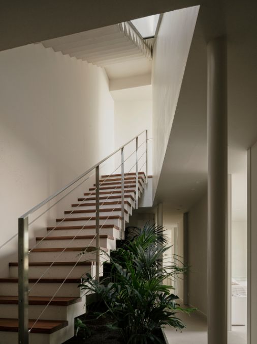 A straight staircase with metal railings