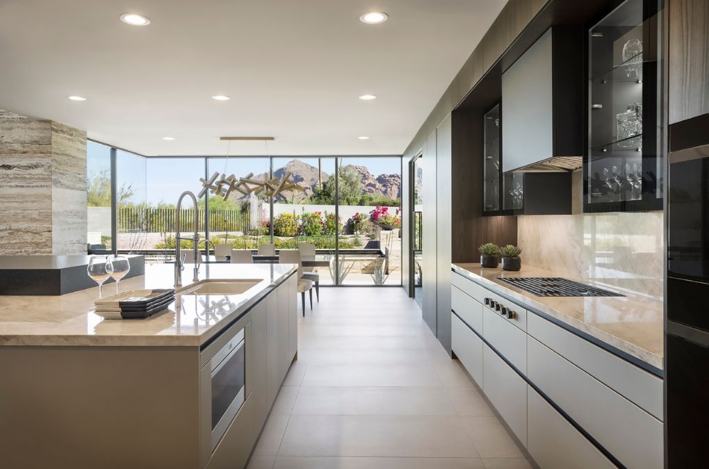 A kitchen features a center island and a cabinet