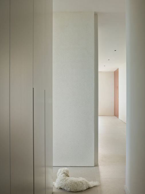 A hall way with white wall, flooring and ceiling