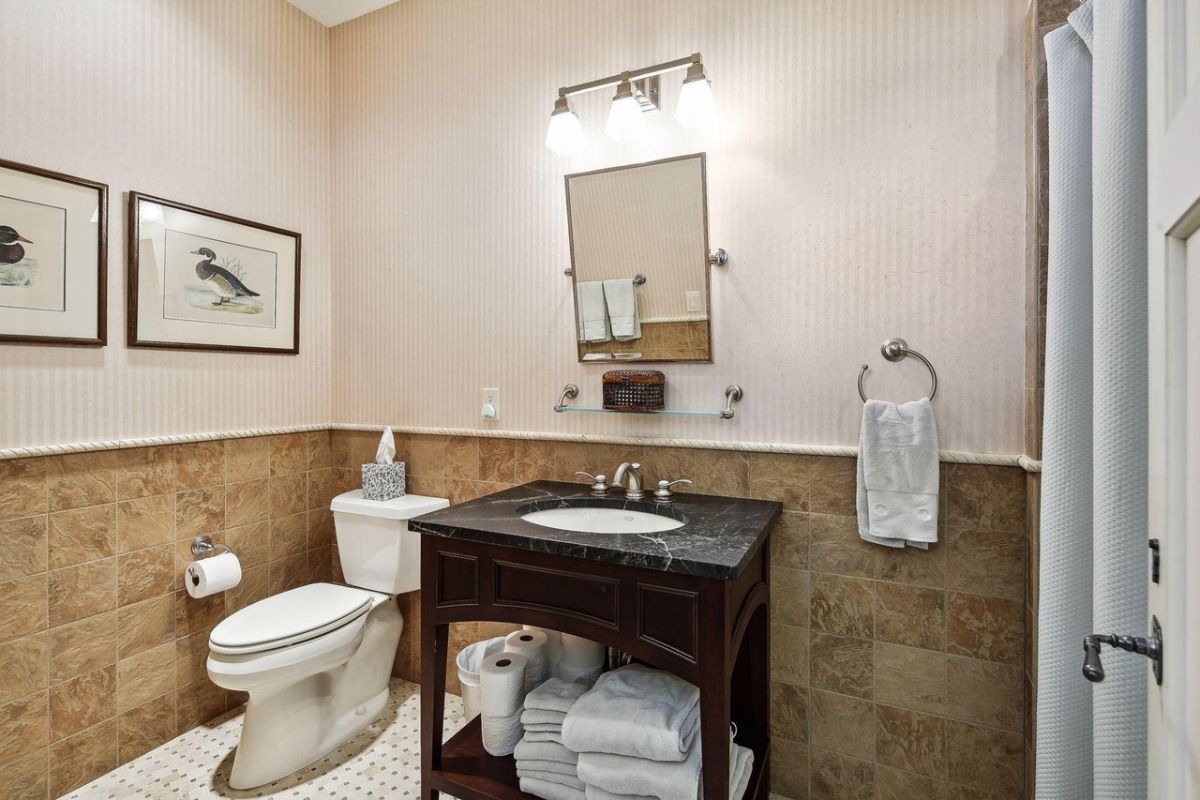 Bathroom with a sink, toilet and towels.