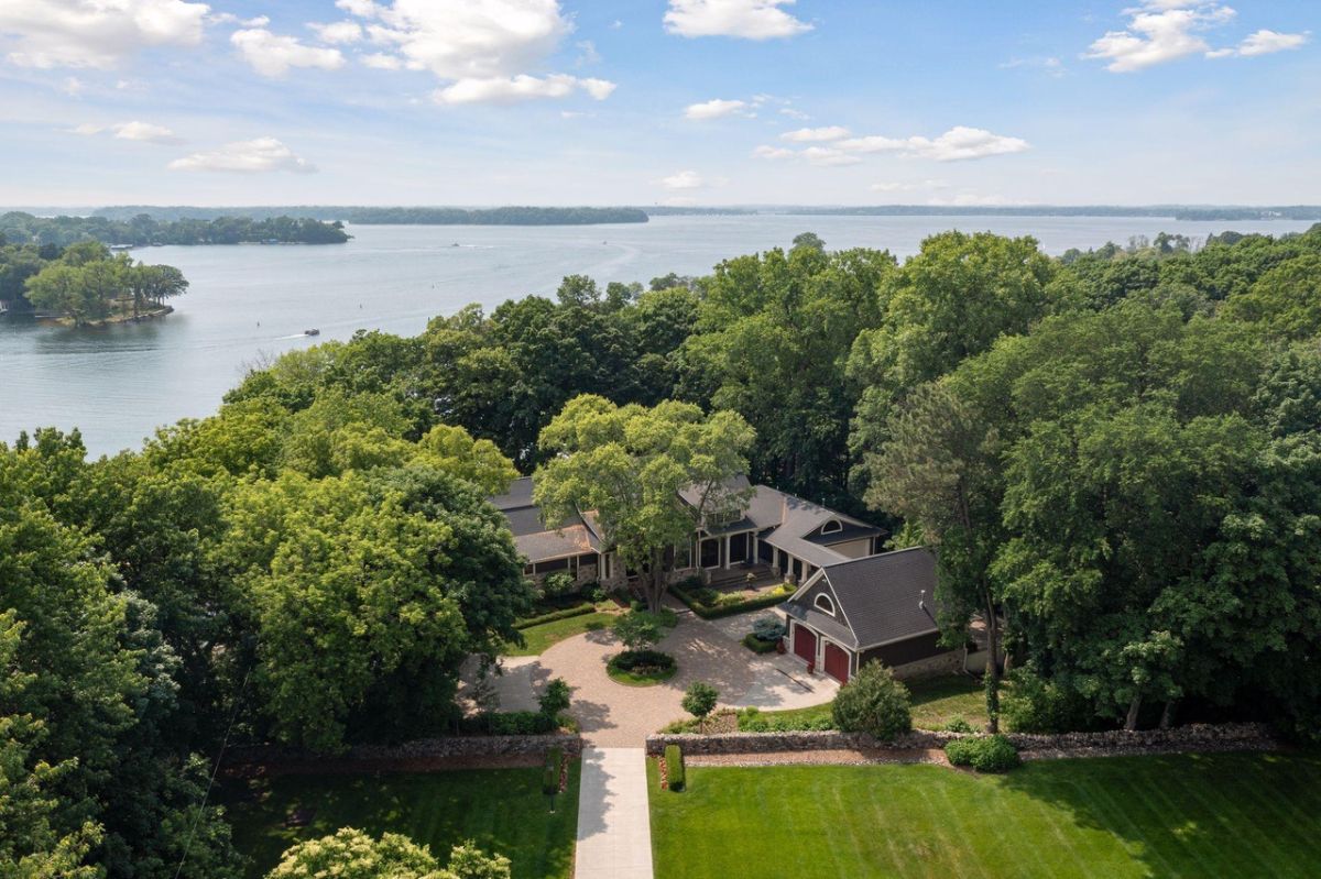 Aerial view of the estate with a lake view in the background.