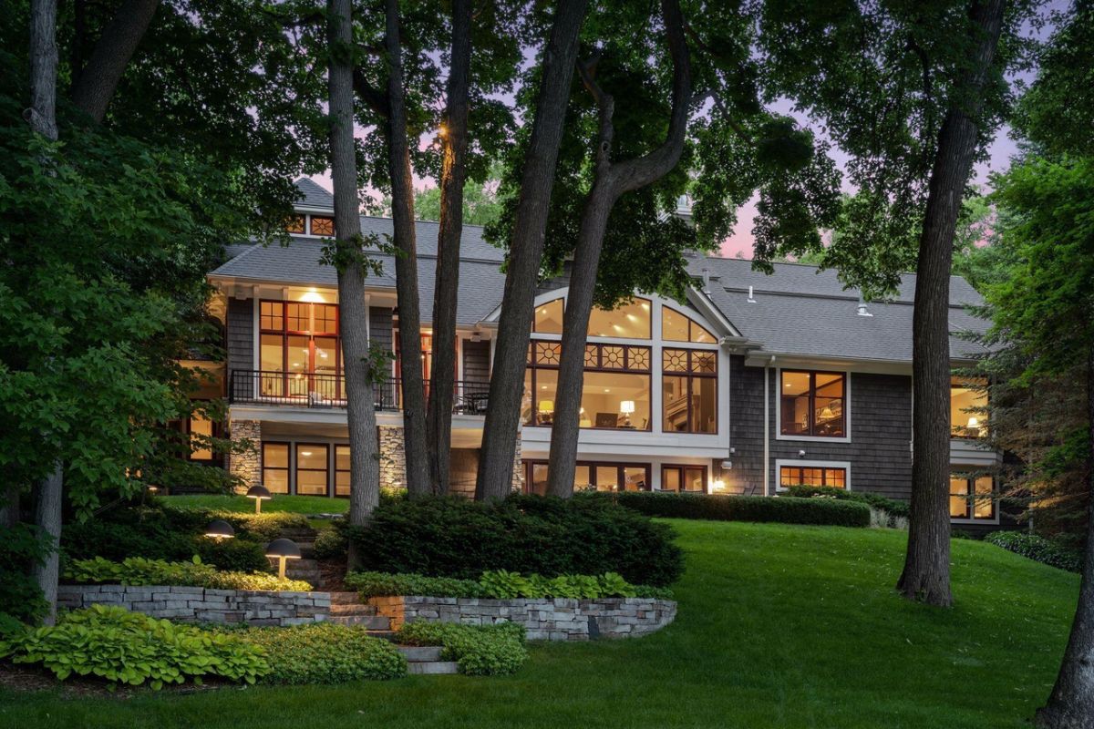 Rear view of the house with a large green backyard.