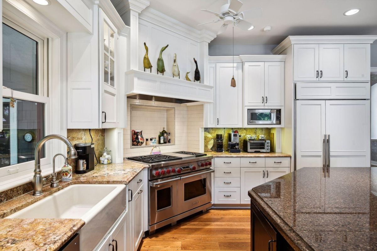 Kitchen with white cabinets and granite countertops.